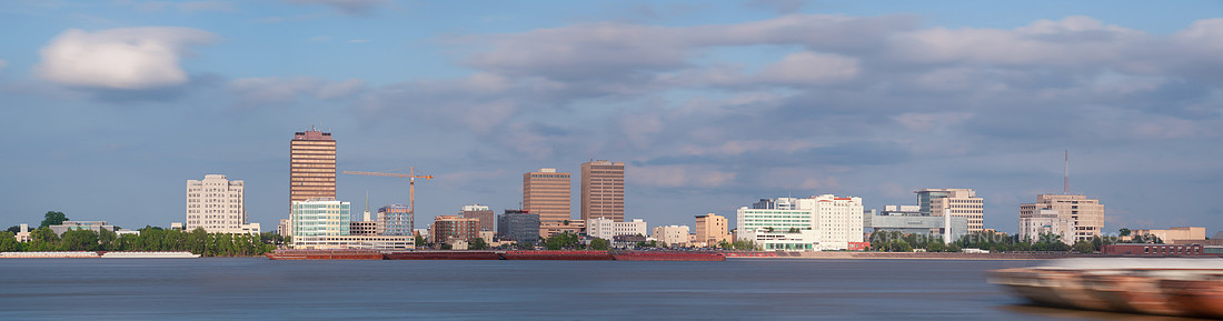 Barges on the Mississippi River in front of the Baton Rouge skyline | Louisiana Travel Photographer Mark Bienvenu