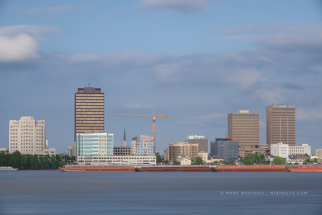 Barges on the Mississippi River in front of the Baton Rouge skyline | Louisiana Travel Photographer Mark Bienvenu