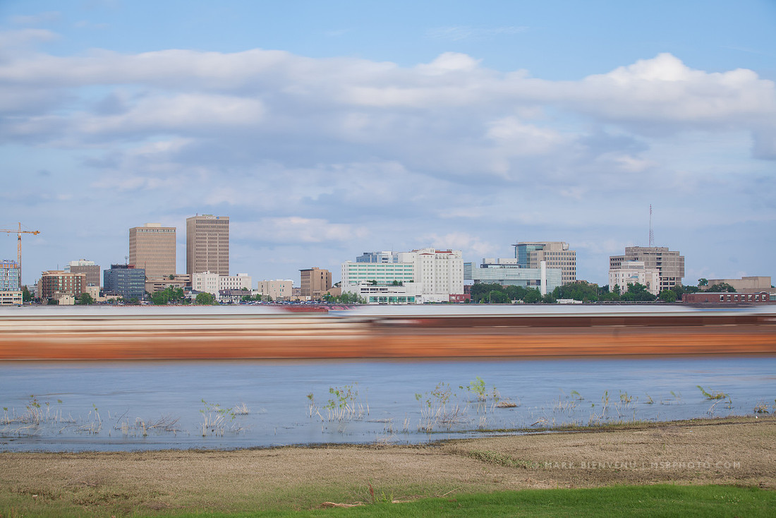 Barges on the Mississippi River in front of the Baton Rouge skyline | Louisiana Travel Photographer Mark Bienvenu